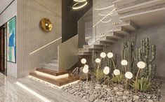 the interior of a modern house with cactus and rocks in the foreground, stairs leading up to the second floor