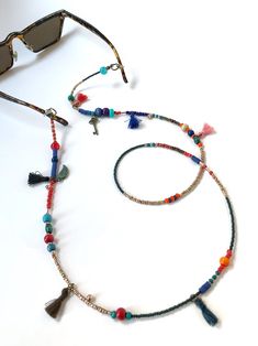 Unisex Bohemian Glasses Chain,Handmade Ethnic Sunglasses Cord,Key Charm Beaded Eye Glass Holder,Tussel Mask Chain,Gift for Her,Long Necklace If you are tired of playing hide and seek with your glasses and masks, there is a colorful news for you! Thanks to our handmade eyeglass straps, which make it almost impossible to lose glasses and give life to boring frames, you can wear your glasses comfortably by hanging them on your neck when not wearing them. It completes your full BOHO chic look! You c Adjustable Summer Jewelry With Tassels, Adjustable Tassel Jewelry For The Beach, Adjustable Tassel Jewelry For Beach, Summer Festival Jewelry With Tassels, Bohemian Glasses Chains With Adjustable Chain As Gift, Adjustable Multicolor Glasses Chains For Festivals, Bohemian Handmade Glasses Chains For Festivals, Multicolor Beaded Glasses Chains For Festival, Bohemian Beaded Glasses Chain As Gift