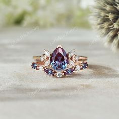 a ring with an amethorate and blue topaze surrounded by diamonds