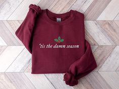 This embroidered 'tis the damn season crewneck is the perfect addition to your winter / Christmas wardrobe. Whether you're wearing it to a Christmas party, or just need more sweater weather crewnecks, this is the perfect unisex sweatshirt for you! Our crewnecks use the highest quality material for ultra-soft and comfortable wear, with advanced printing to ensure vibrant colors and detailed graphics. Note: White, grey, light blue, and light pink crewneck sweatshirts are embroidered with black thr Tis The Damn Season, Thankful Sweatshirt, Sweat Vintage, Funny Thanksgiving Shirts, Crewneck Sweatshirt Women, Xmas Sweater, Mama Sweatshirt, Funny Thanksgiving, Thanksgiving Shirts