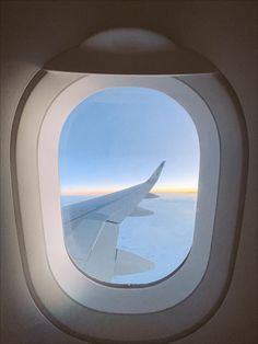 an airplane window looking out at the sky