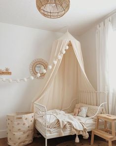 a baby's room with a canopy bed and toys