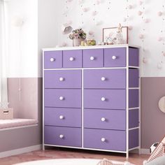 a child's bedroom with pink and purple furniture