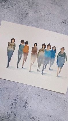 a piece of paper with watercolor drawings of people walking down the street on it