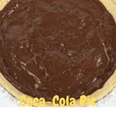 a chocolate pie sitting on top of a white tablecloth with the words cocoa cola pie written below it