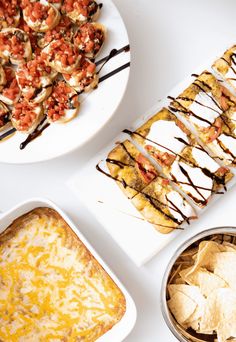 several different types of food on plates and serving trays with dip, tortilla chips, salsa, and quesadilla