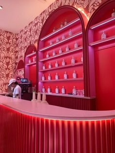 the interior of a store with red walls and shelves