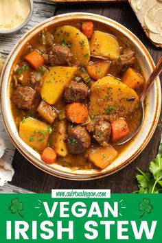 a bowl of irish stew with meat, potatoes and carrots in it on a wooden table