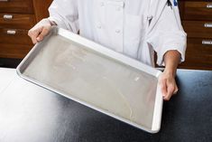 a chef is holding a tray with food on it