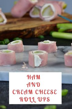 ham and cream cheese rolls on a cutting board with chopsticks next to them