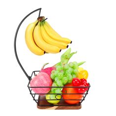 a metal basket filled with lots of different types of fruits and vegetables on top of each other