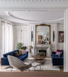 a living room filled with furniture and a fire place in the middle of a room