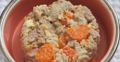 a close up of a bowl of food with carrots and meat in it on a table