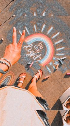 two people standing next to each other with their hands in the air and writing on the ground