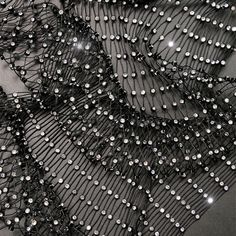 black and white photograph of beaded fabric