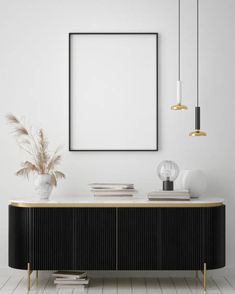 a black and gold sideboard in a white room with an empty poster on the wall