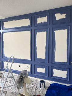 the walls are being painted blue and white