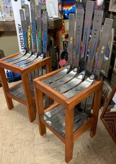 two wooden chairs with skis on them sitting next to each other in a store