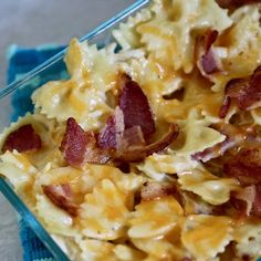 a casserole dish with bacon and cheese in it on a blue glass plate