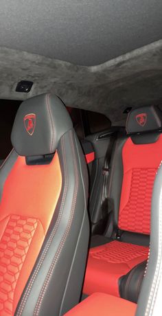 the interior of a car with red and black seats