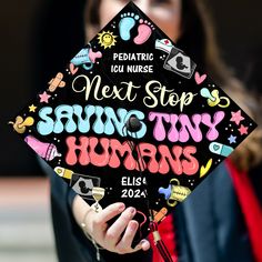 a woman wearing a graduation cap that says next step saving tiny humans on it's side