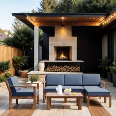 an outdoor living area with couches and fire place