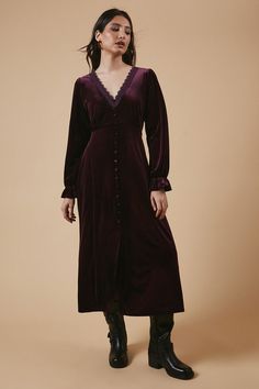 Luxurious velvet fabric for a soft, tactile feel Elegant V-neckline adorned with delicate lace trim Button-through front for a classic, feminine touch Midi length offering versatile styling options Long sleeves with subtle gathering for added interest Embrace effortless elegance with this enchanting velvet midi dress from Oasis. The sumptuous fabric drapes beautifully, creating a flattering silhouette that's perfect for a range of casual occasions. The lace-trimmed V-neckline adds a touch of romance, while the button-through front allows for customisable coverage. Style this versatile piece with ankle boots and a leather jacket for a chic daytime look, or dress it up with heeled sandals and statement earrings for an evening out. The midi length makes it ideal for family gatherings or bru Dresses Velvet, Classic Feminine, Oasis Dress, Velvet Midi Dress, Oasis Fashion, Velvet Lace, Lace Midi, Draped Fabric, Lace Midi Dress