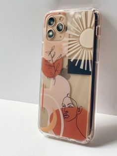 an iphone case is shown on a white surface with the sun in the sky behind it