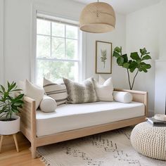 a living room filled with furniture and a fire place in front of a large window