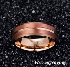 a rose gold wedding band with two different colored bands on top of black glitter background