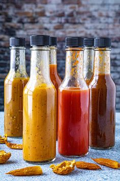 several bottles filled with different types of sauces