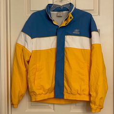 Lined Water Proof Windbreaker Jacket From Sketchers. Rarely Find. Bright Yellow With Grayish Blue (Iron Blue)) And White. Hood Folded And Zipped Around The Neck Line. Two Side Pockets With Zipper. One Zipped Pocket Inside As Well. Blue And Yellow Fashion, Retro Yellow Windbreaker For Spring, Retro Yellow Windbreaker For Winter, Retro Yellow Windbreaker For Fall, Retro Yellow Hooded Windbreaker, Yellow Hooded Track Jacket For Winter, Yellow Casual Track Jacket For Outdoor, Sporty Yellow Outerwear For Winter, Casual Yellow Track Jacket For Outdoor