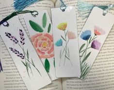 four bookmarks with flowers painted on them