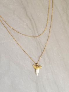 "This fun necklace set uses a dainty satellite chain to keep with the trend and features a genuine shark tooth. The set can be made in 14k Gold Fill or Sterling Silver with your choice of gold/silver plated white or gray shark tooth. You can wear the necklaces together or separately. The necklaces are made in lengths 2 inches apart to stagger them appropriately. Shown in 16\" and 18\" lengths. 2 piece set includes: 1) Dainty Satellite Chain 2) Genuine Shark Tooth on Satellite Chain *If you would White Double Strand Clavicle Chain Jewelry, White Double Chain Necklace Gift, White Double Strand Jewelry With Double Chain, White Double Strand Chain Jewelry, White Double Strand Jewelry With Delicate Chain, White Layered Necklace With Adjustable Chain As Gift, White Layered Necklace With Adjustable Chain For Gift, White Double Chain Jewelry Gift, White Double Chain Jewelry As Gift