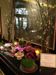 the buffet table is decorated with flowers and fruit