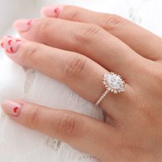 a woman's hand with a diamond ring on it