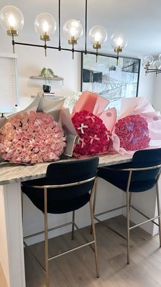 flowers are sitting on the counter in front of two chairs