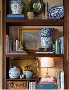 a bookshelf filled with vases and other items