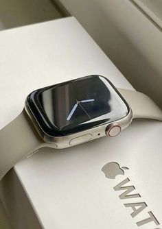 an apple watch sitting on top of a white box with the logo for its brand