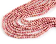 These 3mm rhodonite rounds are a splash of rosy pink that's great for dainty jewelry creations. Add detail to strung bracelets and necklaces or incorporate into minimalist earring designs. Rhodonite, from the Greek word “rhodon” meaning rose, is a pink colored manganese silicate. It is often confused with rhodochrosite, which is a rose colored manganese carbonate. The two gemstones are often found in close proximity. Rhodonite is often marbled with a black matrix of manganese oxide. Metaphysical Rosy Pink, Greek Words, Beads Online, Bead Store, Rose Color, Dainty Jewelry, Minimalist Earrings, Jewelry Creation, Designer Earrings