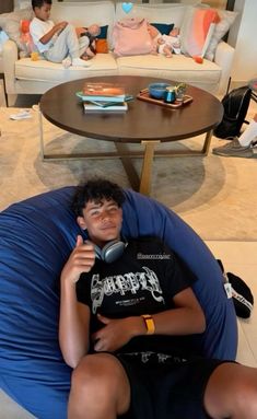 a young man sitting in a bean bag chair