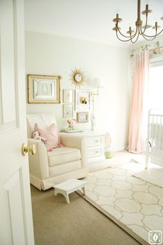 a baby's room is decorated in white and pink