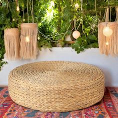 a round woven ottoman sitting on top of a rug