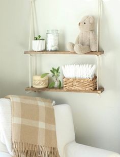 a teddy bear sitting on top of two shelves