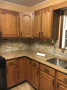 a kitchen with wooden cabinets and granite counter tops