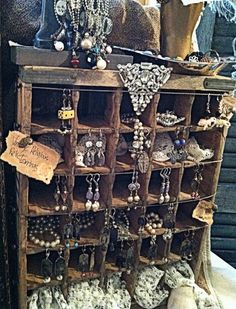 an old wooden jewelry rack filled with lots of necklaces