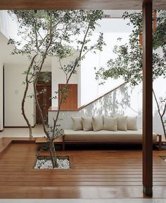 a living room filled with furniture and trees