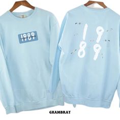 two blue sweatshirts with numbers on them