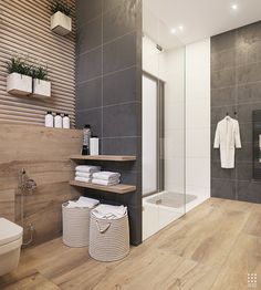 a modern bathroom with wood flooring and tile walls, along with white towels on the shelves