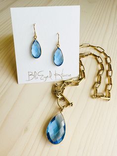 Beautiful, faceted Aquamarine quartz gemstone earrings in a briolette shape and set in a gold-plated bezel. These hang approximately 1” in length and hang from a non-allergen gold plated over brass ear wire. These are very lightweight. Because these are faceted stones, they truly catch the light and have a striking sparkle in the sun. Shown with our Aquamarine Necklace Handcrafted by BluEyed Horse in the USA. Exclusive and original. They will arrive wrapped, perfect for gift giving! Aquamarine Earrings, Aquamarine Necklace, Aquamarine Gemstone, Detail Shop, Ear Wire, Gift Giving, Gemstone Earrings, Aquamarine, Nature Inspiration